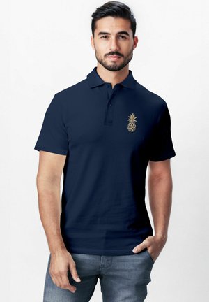 Navy polo shirt made of cotton with short sleeves, featuring a gold pineapple logo on the left chest area and a classic collar design.