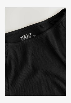 Black ribbed slash neck top featuring a smooth texture, fitted design, and a label visible on the neckline.