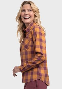 Karohemd in Orange und Lila; lange Ärmel mit einer Brusttasche; leichtes Material; abgerundeter Saum für mehr Bewegungsfreiheit.