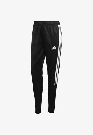 Pantalon de sport noir avec une coupe slim, une taille élastique et trois bandes latérales blanches. Logo affiché sur la cuisse gauche.