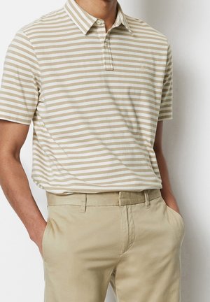 Creme- og beige stribet polo-shirt i bomuld med krave, tre-knaps stolpe og et lille logo på brystet. Sammen med beige bukser.