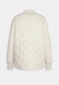 Chaqueta acolchada de color crema con cuello, puños elásticos y tela texturizada. Presenta un diseño sencillo y limpio sin herrajes visibles.