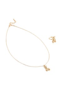 Guld halskæde og ring sæt, hver med en lille poleret teddy bjørn vedhæng på en fin kæde og ring mod en hvid baggrund.