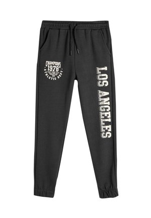 Schwarze Sweatpants aus einem Baumwoll-Mix. Sie verfügen über einen elastischen Bund, Seitentaschen und bedruckte Designs: "Champions 1978" und "Los Angeles."