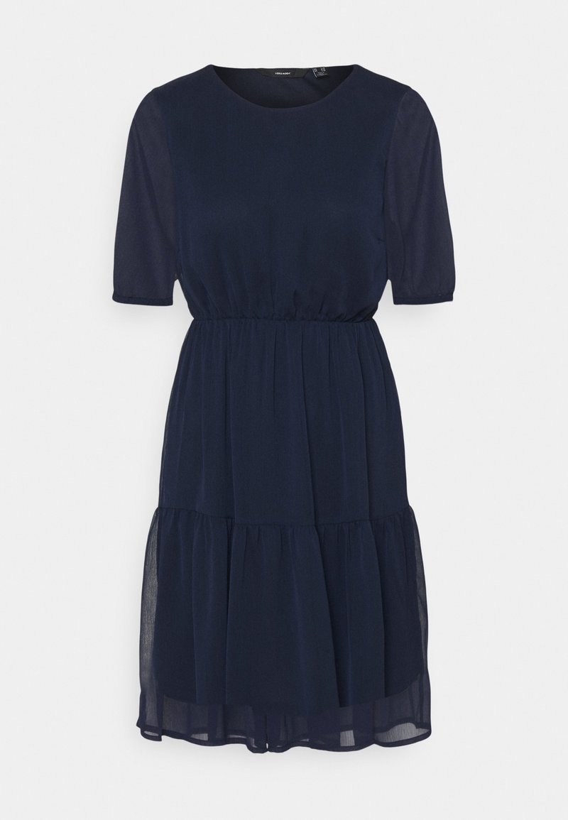 Sinih navy'lla polvili, lyhyt-hiha nostovöidä, kerroksellinen hame ja läpinäkyvä kangas päällimmäisenä.