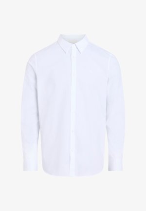 Valge triiksärk pika varrukaga, klassikalise kraega, valmistatud sileda kangaga, esiküljel nööpidega ja ümarate servadega.