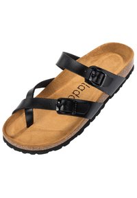 Sandale à bout ouvert avec une semelle en liège, doublée de suède beige, et deux brides en cuir noir réglables avec boucles sur le dessus.