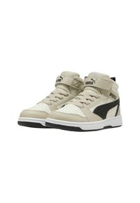 Sneakers alta beige con accenti neri, caratterizzati da dettagli perforati, lacci beige e una tracolla in Velcro. Suola in gomma.