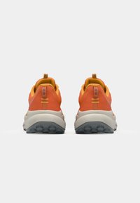 Orange and gray athletic shoes with textured uppers, padded collars, and rugged soles. Features contrasting yellow accents and pull tabs.