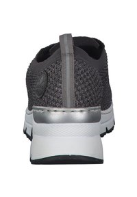 Gray knitted sports shoe with a silver accent at the heel, a textured back, and a white midsole. Features a pull tab for easy wear.