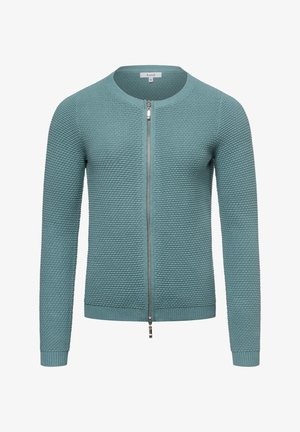 Strikket zip-op cardigan i teal med et tekstureret mønster, rund halsudskæring og ribbede manchetter og kant. Lynlåsen strækker sig op til kraven.