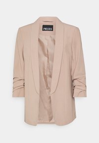 Blazer beige con collo sciallato, silhouette strutturata, maniche arrotolate e fodera interna liscia. Etichetta del brand visibile all'interno.