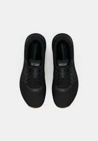 Juodi Reebok Nano XV batai su tinkleliu viršuje, tekstūruota danga ir guminiu padu; turi plokščiąsias raišteles ir paminkštintą apykaklę.