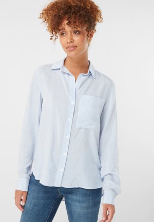 Light blue long-sleeve button-up shirt with white vertical stripes, single chest pocket, and a relaxed fit. Crafted from soft fabric.