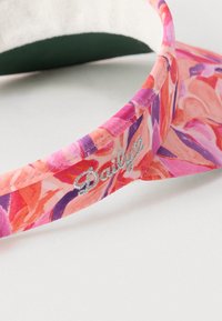 Vizir kapa s uzorkom cvijeća u ružičastim, ljubičastim i narančastim tonovima; ima teksturiranu tkaninu i izvezeni natpis "Daily" na traci.