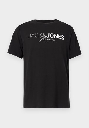 Musta lyhythihainen T-paita, jossa valkoinen "JACK & JONES premium" -teksti rinnassa, esitettynä vaaleaa taustaa vasten.