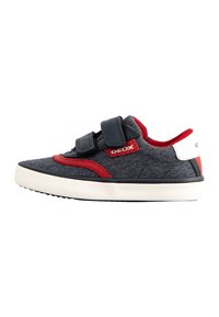 Sneakers Geox con una toma superiore in tessuto blu scuro, dettagli rossi e una strap in Velcro. Suola in gomma bianca con grip testurizzato per una buona aderenza.