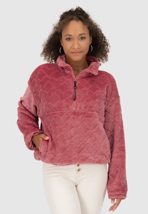 Fleece-Pullover in einem Verlauf von Pink mit Herzmuster, Viertel-Reißverschluss-Kragen, Stehkragen und seitlichen Taschen. Weiches und gemütliches Design.