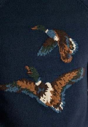 Two multicolored ducks in flight knitted in brown, blue, white, and green on a dark navy blue fabric background.