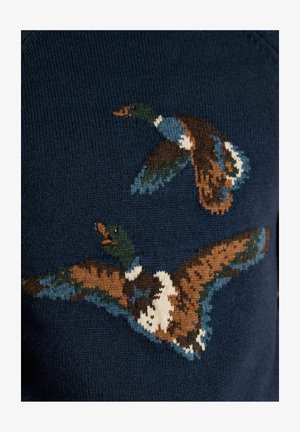 Two multicolored ducks in flight knitted in brown, blue, white, and green on a dark navy blue fabric background.