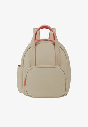 Beige backpack with a rounded design, dual pink straps, a front zip pocket, and a side mesh pocket. Textured fabric with a smooth finish.