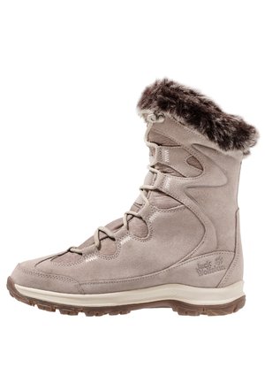 Botte d'hiver marron clair avec doublure en fourrure, lacets à l'avant et semelle robuste conçue pour temps froid et usage extérieur.
