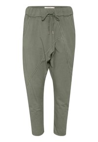 Pantalons de jogging en mélange de coton vert avec une coupe fuselée, taille élastique, cordon de serrage et accents de couture diagonale. Comprend des poches latérales.