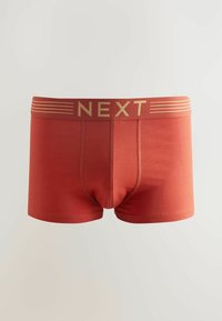 Boxer-briefs en coton rouge avec un logo doré "NEXT" sur la ceinture et des rayures horizontales. Présente un ajustement serré et des détails cousus.