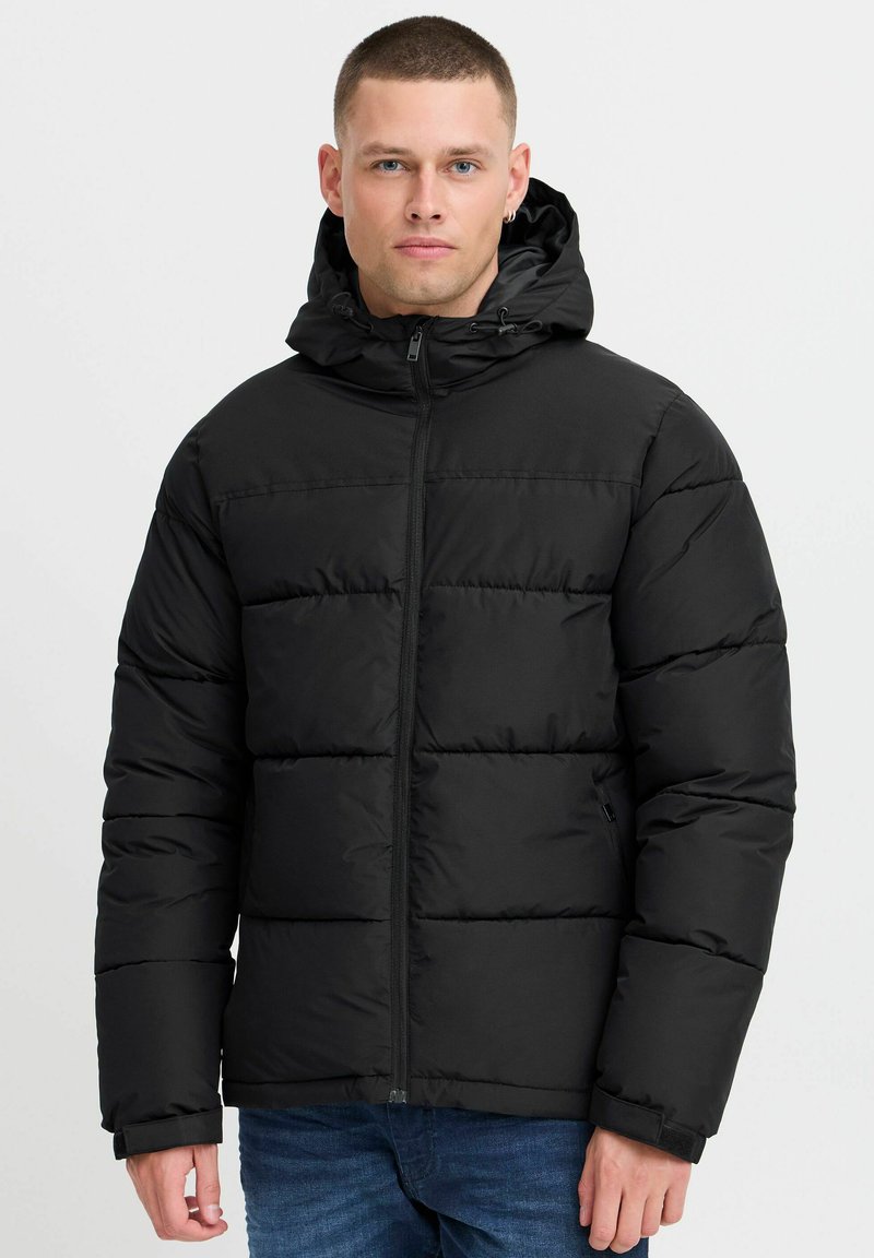 Black puffer jacket with a hood, featuring a zip closure, quilted design, and elastic cuffs. Smooth fabric with a matte finish.