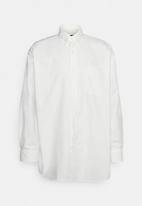 Vit långärmad skjorta med knappar, gjord av bomull. Har en krage, frampocket och knapppunkter längs knappslån och ärmar.