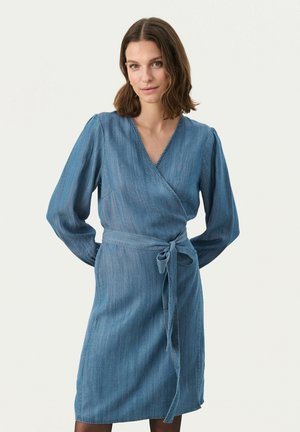 Denim wrap dress in light blue with long sleeves, v-neck, and tied belt at waist. Features a smooth texture and straight hemline.