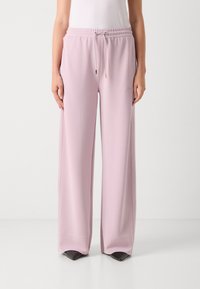 Light pink wide-leg sweatpants with an elastic waistband and drawstring; made from soft fabric, featuring an embroidered logo on the thigh.