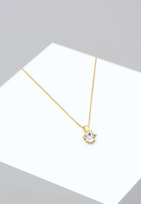 Collier en or avec une fine chaîne et un pendentif en pierre précieuse ronde et transparente, doté de six griffes et d'une finition polie.