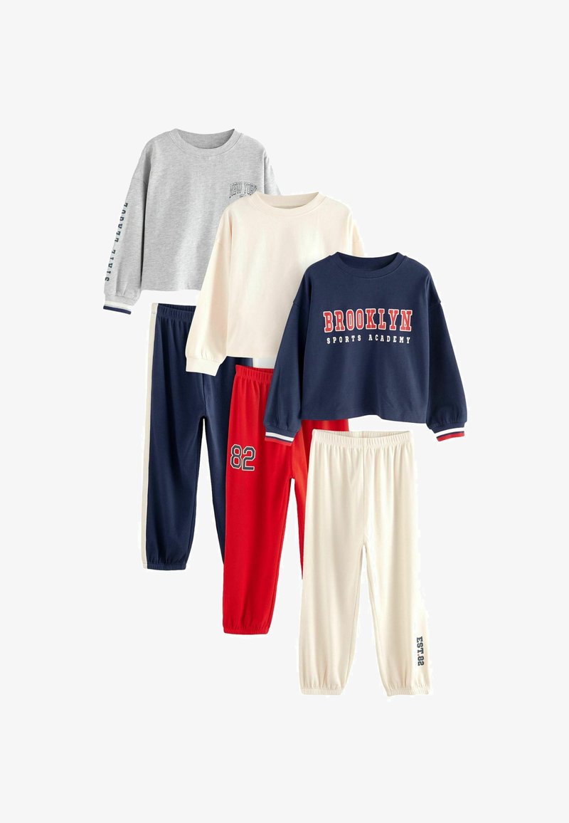 Set of four matching athletic outfits: gray and white sweatshirts, navy and red pants; varied text and numbers; cotton material; casual fit.