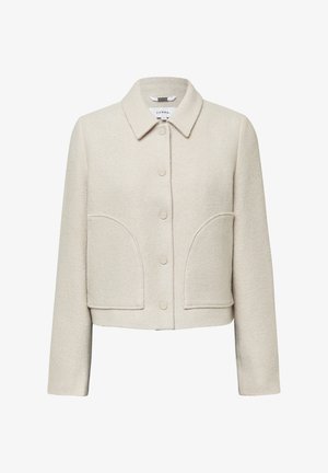 Helle beige, kurz geschnittene Jacke aus strukturiertem Stoff. Verfügt über einen Kragen, eine durchgehende Knopfverschluss und zwei große aufgesetzte Taschen vorne.