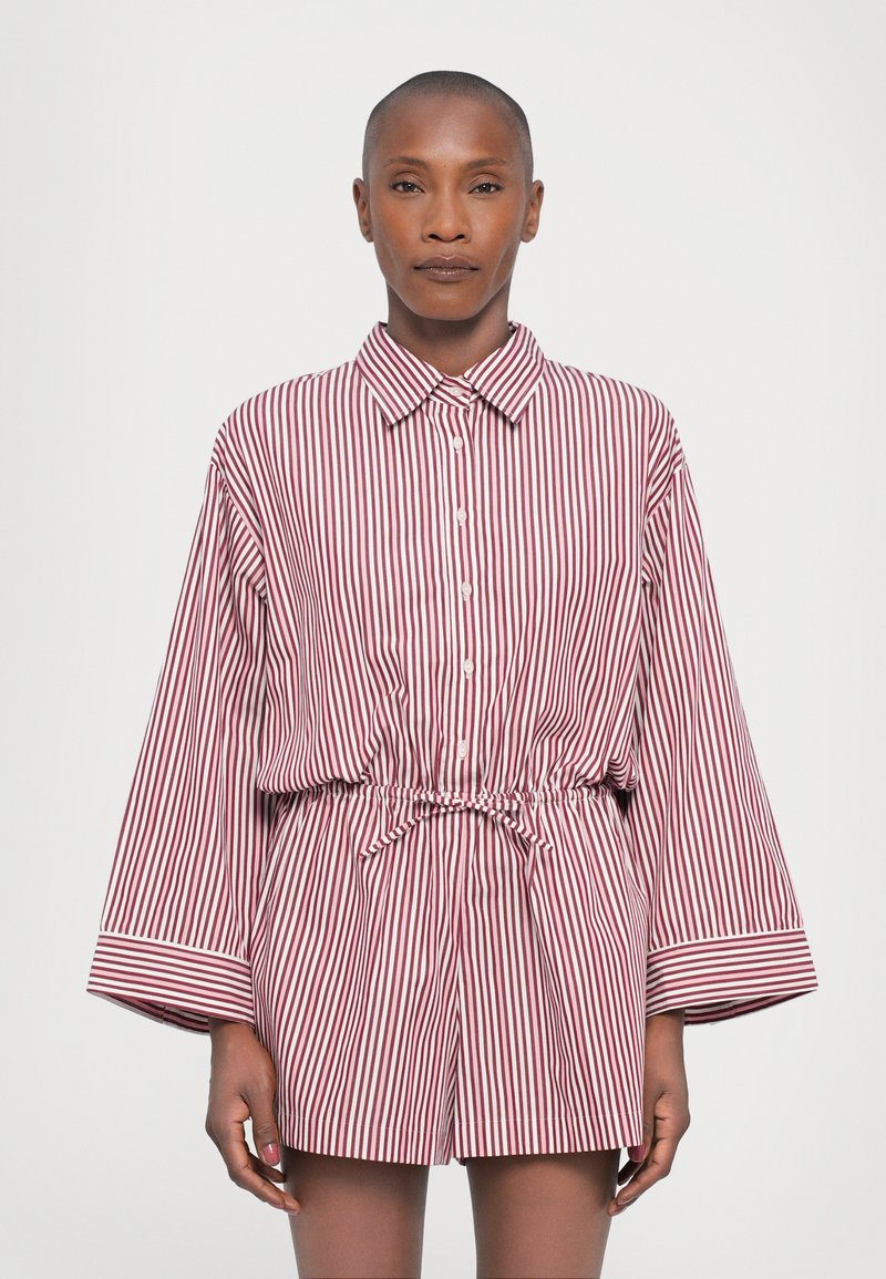 Striped shirt dress in red and white, featuring a button-down front, long sleeves, and a cinched waist with a drawstring. Smooth fabric texture.