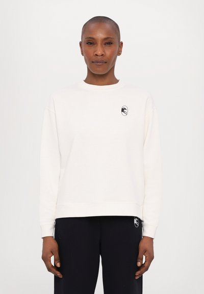 Cream sweatshirt with a round neckline, long sleeves, and a black logo on the chest. Soft fabric and relaxed fit design.