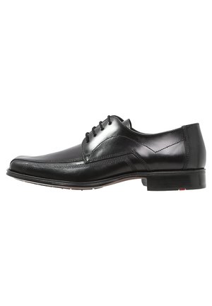 Black leather dress shoe with a smooth finish. Features a rounded toe, lace-up design, and subtle stitching accents. Low heel.