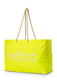 Helle gelbe Tragetasche aus strapazierfähigem Material, mit dicken, cremefarbenen Seilgriffen und dem Wort "nōbo" in Weiß bedruckt.