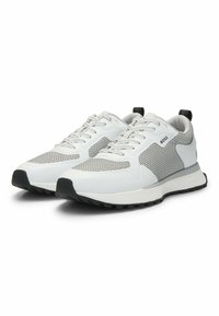 White athletic shoes with mesh overlay and padded ankle collar. Features grey accents, lace-up design, and black rubber outsole.