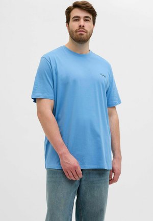 Light blue cotton t-shirt with short sleeves, featuring a round neckline and a small logo on the chest. The fabric appears soft and smooth.
