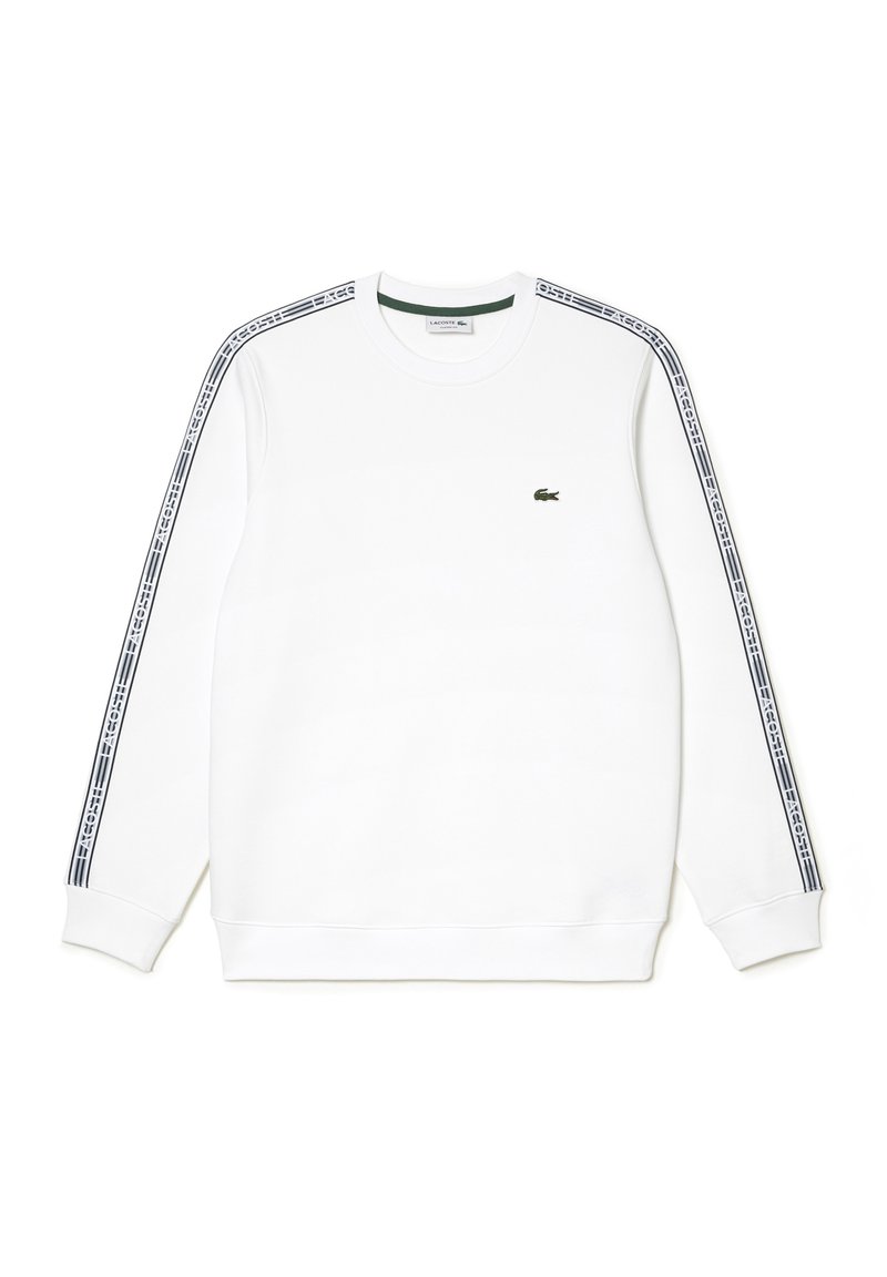 Sweatshirt blanc avec des manches longues, des poignets côtelés et un col rond. Accentué de rayures navy et d'un petit logo sur la poitrine.