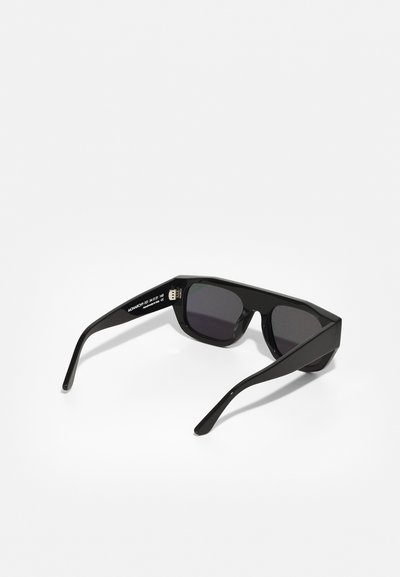 Black sunglasses with rectangular lenses. Made of plastic, featuring thick, angular frames and slender arms. No visible patterns or accents.