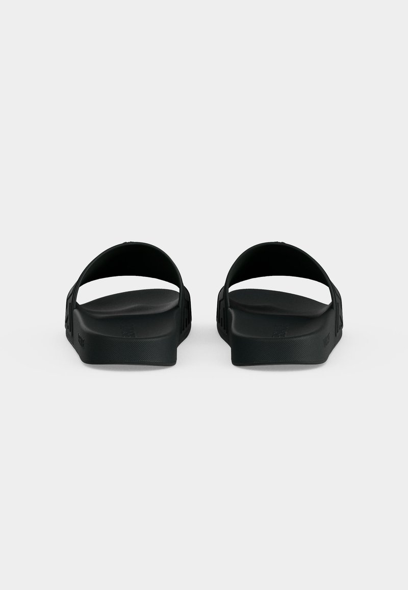 Pair of black slip-on sandals shown from the back with wide straps and flat cushioned soles on a plain background.