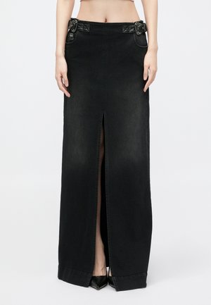 Jupe maxi en denim noir avec une fente sur le devant, deux poches latérales et des boucles décoratives à la taille. Texture lisse et design ajusté.