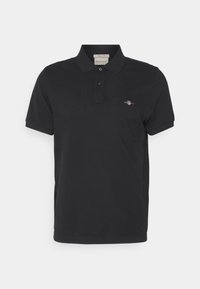 Polo noir en coton, doté d'un col classique, d'une patte de boutonnage à trois boutons et d'un petit logo brodé sur la poitrine.