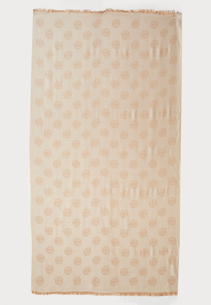 Beige vævet tæppe med et gentagende cirkulært mønster. Kanterne har let frynse-detaljering. Materialet ser blødt og tekstureret ud.