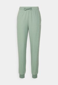 Ljusgröna sweatshirtbyxor med elastiskt midjeband, justerbar dragsko och muddar vid anklarna. Mjuk textur, avslappnad design. Logotyp på sidan.