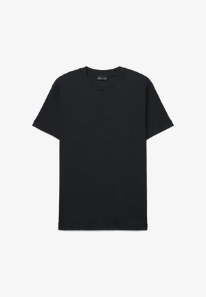 Plain black short-sleeve crewneck T-shirt laid flat with visible brand label at neckline against a white background.