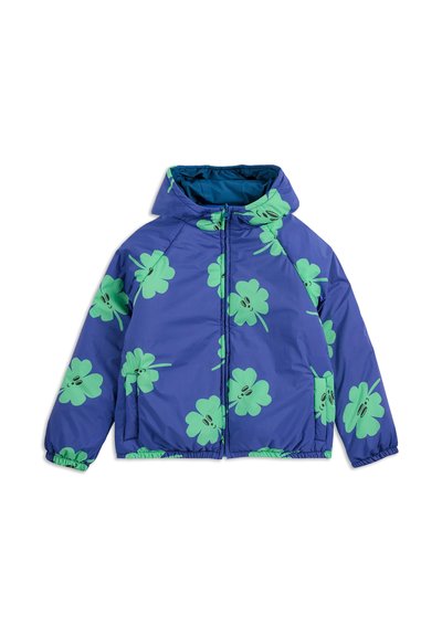 Veste bleu gonflante avec des motifs de trèfle verts, fermeture éclair sur le devant, manches élastiques et capuche. Elle dispose de deux poches latérales et d'une texture lisse.